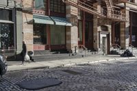 a street scene with old buildings and bicycles parked on the sidewalk, on a sunny day