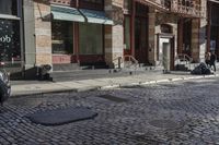 a street scene with old buildings and bicycles parked on the sidewalk, on a sunny day