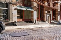 a street scene with old buildings and bicycles parked on the sidewalk, on a sunny day