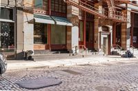a street scene with old buildings and bicycles parked on the sidewalk, on a sunny day