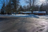 a snowy street in front of a lodge with a roof on it's side