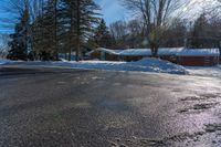 a snowy street in front of a lodge with a roof on it's side