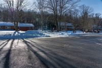 this is a street with lots of snow on it as seen in the sun from behind