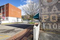 there is a small fence by the entrance to a building on the corner of the street