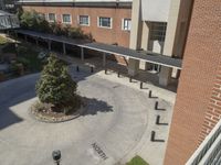 the top view of a building showing a courtyard and two benches with a tree on either side