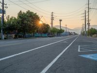 an empty street in front of a large red brick building on the other side of the road is a street light that has a line for motorists