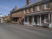 this is a beautiful, old brick building in front of an older, large house