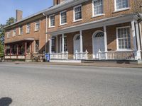 this is a beautiful, old brick building in front of an older, large house