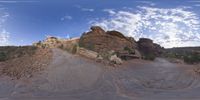 a view from a fish eye lens, of the red rocks and blue sky above