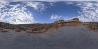 a view from a fish eye lens, of the red rocks and blue sky above