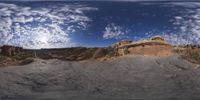 a view from a fish eye lens, of the red rocks and blue sky above