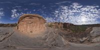 a view from a fish eye lens, of the red rocks and blue sky above