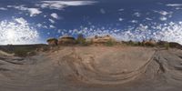 a view from a fish eye lens, of the red rocks and blue sky above