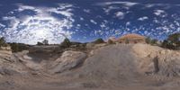 a view from a fish eye lens, of the red rocks and blue sky above