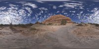 a view from a fish eye lens, of the red rocks and blue sky above