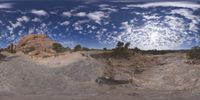 a view from a fish eye lens, of the red rocks and blue sky above