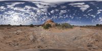 a view from a fish eye lens, of the red rocks and blue sky above