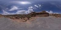 a view from a fish eye lens, of the red rocks and blue sky above