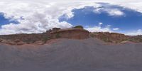 a view from a fish eye lens, of the red rocks and blue sky above