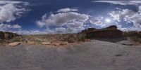 a view from a fish eye lens, of the red rocks and blue sky above