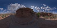 a view from a fish eye lens, of the red rocks and blue sky above