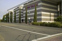 a parking garage with the name fast times written on it in front of a street