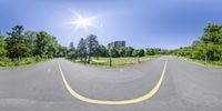 a 360 - view photo of a sunray over a road and a parking area