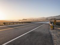 Sunrise on the Yellow Horizon: Asphalt Road Stretching into the Distance