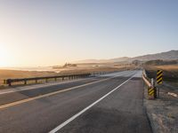 Sunrise on the Yellow Horizon: Asphalt Road Stretching into the Distance