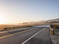 Sunrise on the Yellow Horizon: Asphalt Road Stretching into the Distance