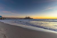 a beach scene during sunrise with the water still up to the ground and the ocean in the background