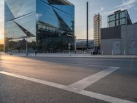 a man on his bike is passing by a building in a city intersection with cars