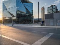 a man on his bike is passing by a building in a city intersection with cars