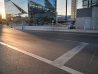 a man on his bike is passing by a building in a city intersection with cars