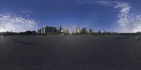 a fish - eye lens image of an empty road and skyline in the distance, on a sunny day