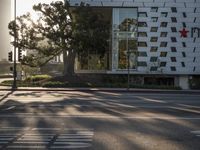 Sunrise over Los Angeles cityscape with modern architecture and tree-lined roads