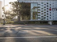 Sunrise over Los Angeles cityscape with modern architecture and tree-lined roads
