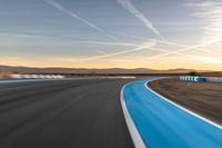 Sunrise at the Race Track: Asphalt Curve and Sun Visible