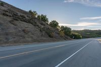 Sunrise on a Rural Road with Mountain View and Tree