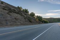 Sunrise on a Rural Road with Mountain View and Tree