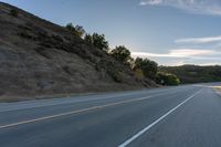 Sunrise on a Rural Road with Mountain View and Tree