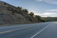 Sunrise on a Rural Road with Mountain View and Tree