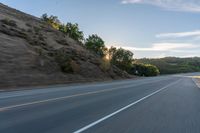 Sunrise on a Rural Road with Mountain View and Tree