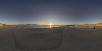 a panorama photo taken on the beach at sunset shows a beautiful body of water and buildings