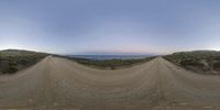 a view from the camera of a very wide street at sunset near the beach, with many steps lined up as shown