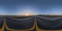 a 3d street view shows two empty road in the sunset while the sun sets over a mountain