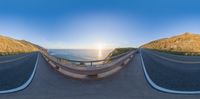 an empty, winding highway is seen at sunset in this 360 - angle shot from above the ground