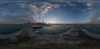 a sunset in chicago from across the water with buildings in the background and the sun setting on the horizon