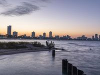 the city skyline is shown at sunset in this image of this photo, the water is empty