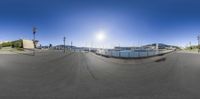 a 360 - view of the sun setting over a parking lot full of boats and ships